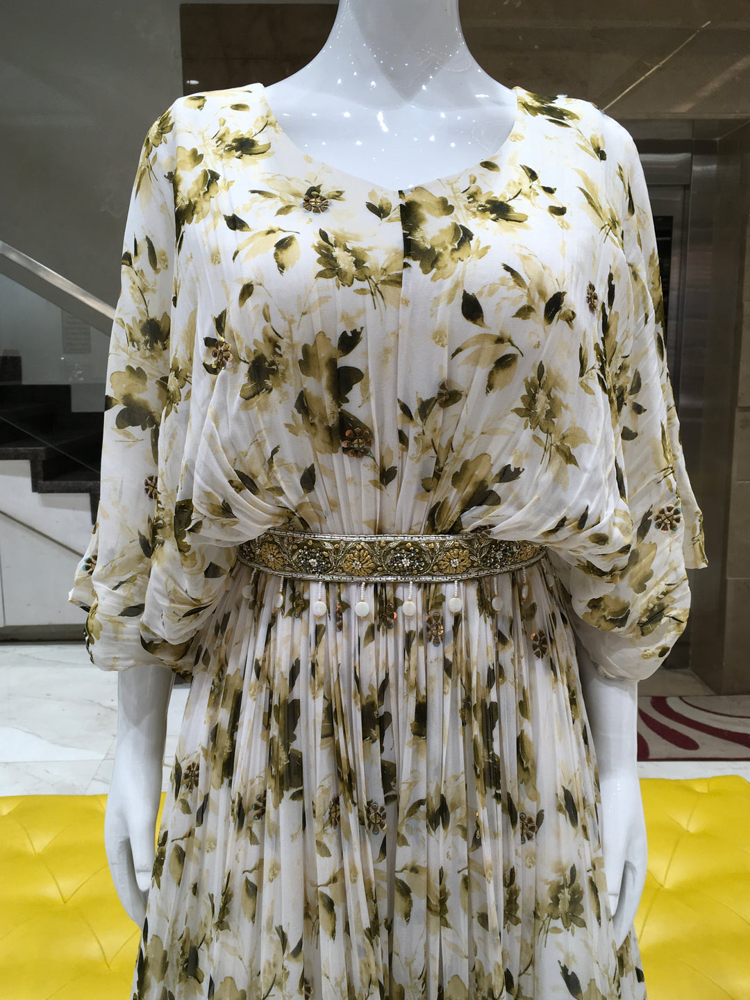 Brown floral print gown in georgette with beaded waistbelt and elegant silhouette