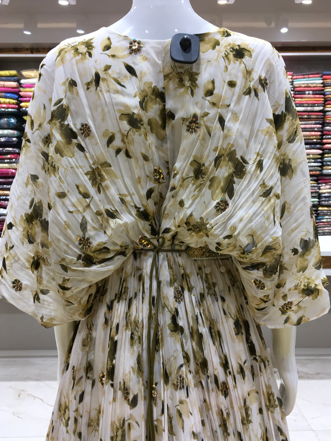 Brown partywear gown with winged sleeves, floral print, and sequin detailing