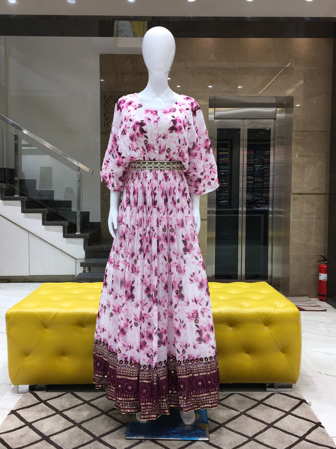 Purple Georgette floral printed gown with broad sequin border and winged sleeves for festive occasions