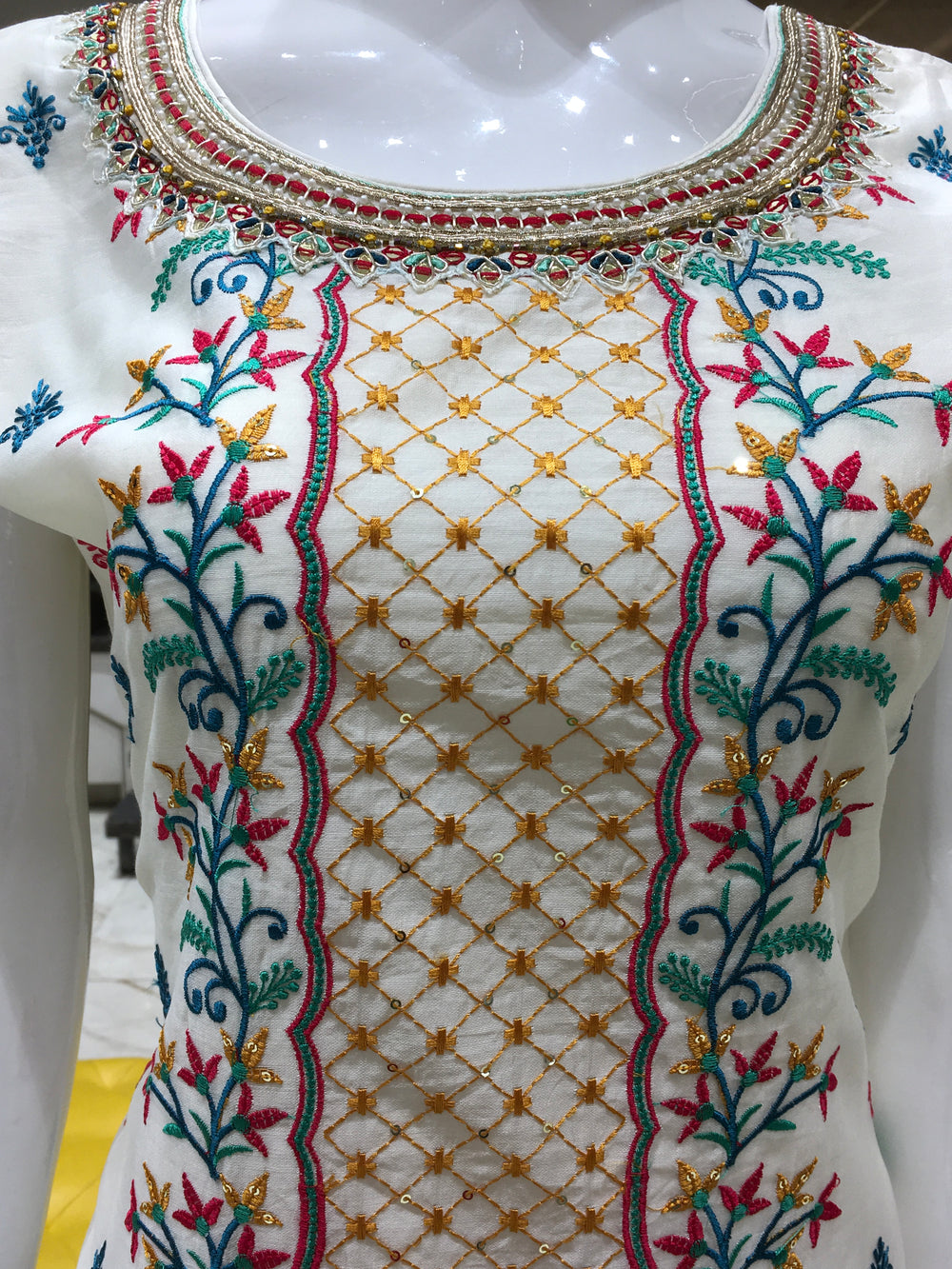 Chanderi Cotton Straight Cut Salwar Kameez with multicolor floral thread embroidery, pencil pants, and a dual-tone chiffon dupatta with sequin detailing.