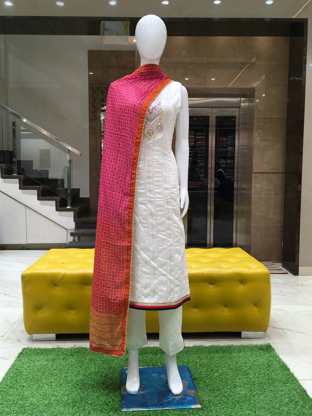 Cream Chanderi Cotton Straight Cut Salwar Kameez with floral threadwork, bead detailing, pencil pant, and contrast rani pink dupatta.