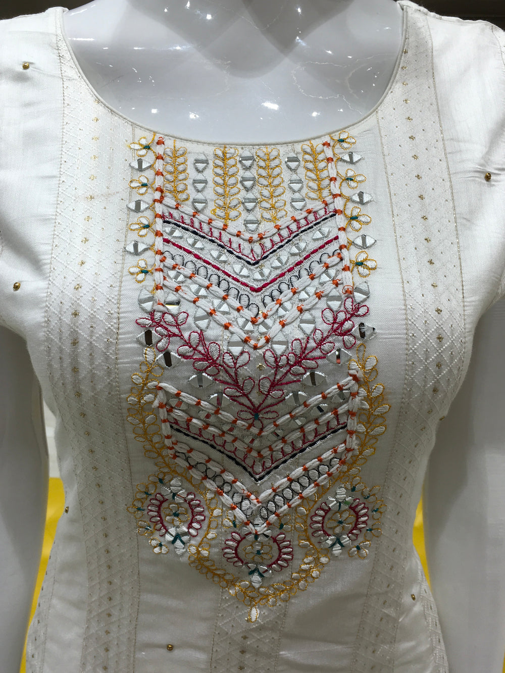 Cream Chanderi Cotton Straight Cut Salwar Kameez with floral threadwork, bead detailing, pencil pant, and contrast rani pink dupatta.