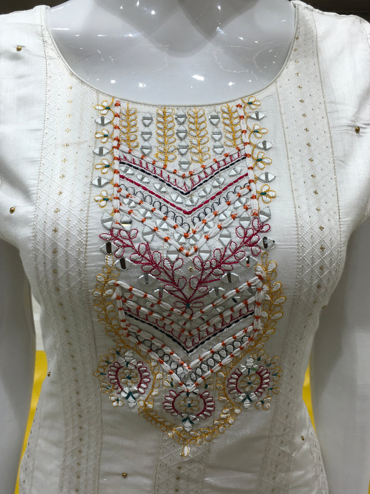 Cream Chanderi Cotton Straight Cut Salwar Kameez with floral threadwork, bead detailing, pencil pant, and contrast rani pink dupatta.