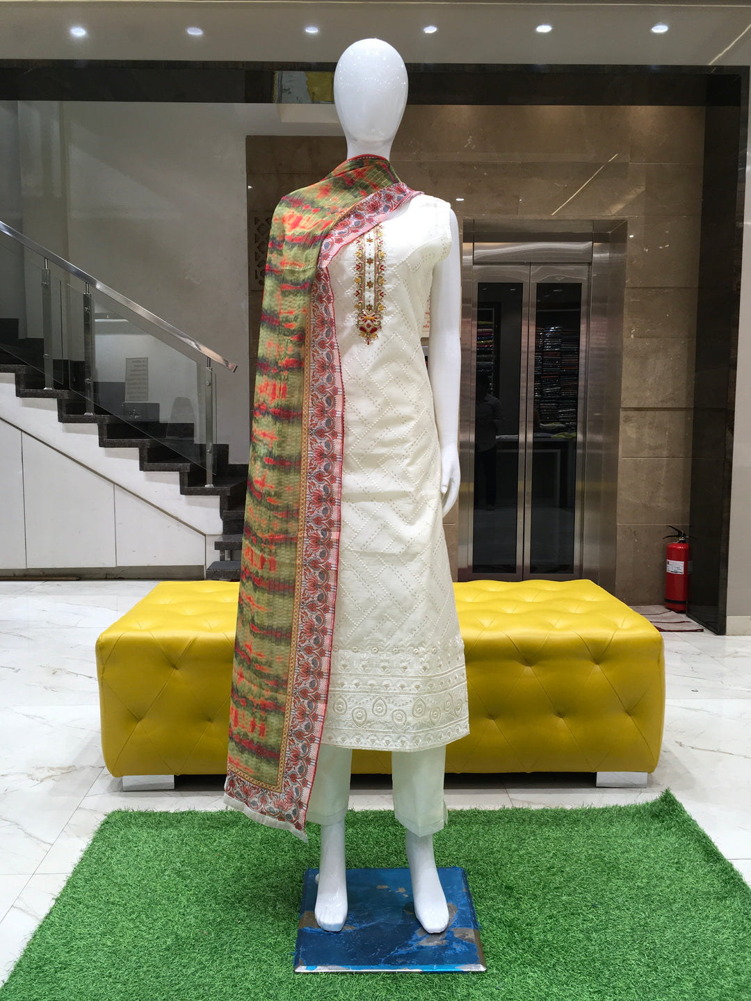 Cream Chanderi Cotton Straight Cut Salwar Kameez with multicolour printed dupatta, subtle embroidery, and sequin highlights, displayed on a mannequin.