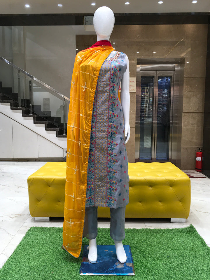Chanderi Cotton Straight Cut Salwar Kameez with multicolor floral thread embroidery, pencil pants, and a dual-tone chiffon dupatta with sequin detailing.