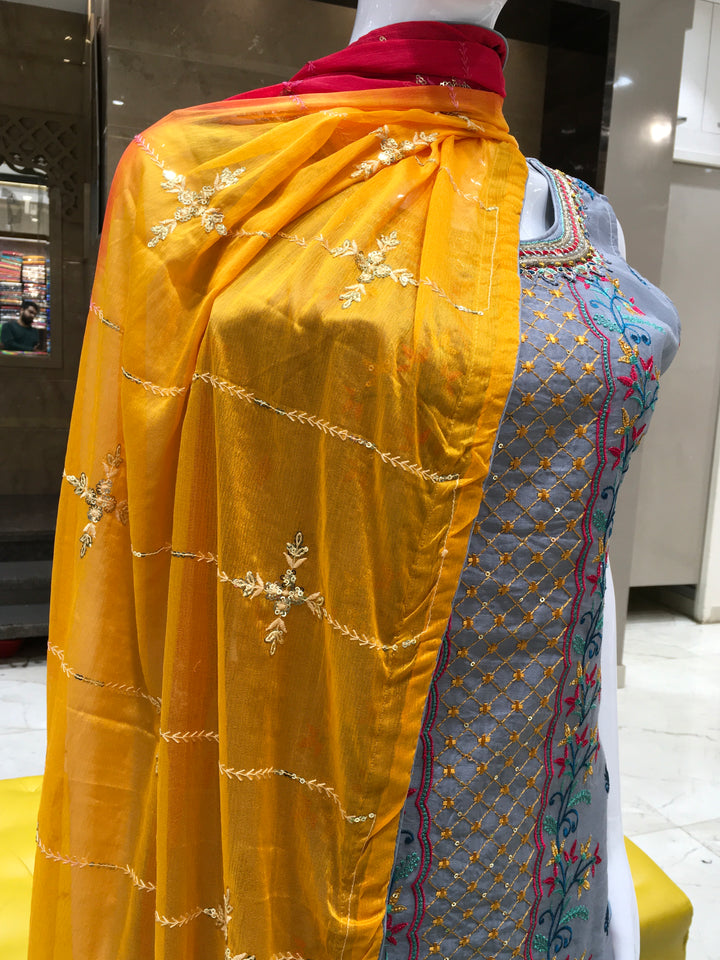 Chanderi Cotton Straight Cut Salwar Kameez with multicolor floral thread embroidery, pencil pants, and a dual-tone chiffon dupatta with sequin detailing.