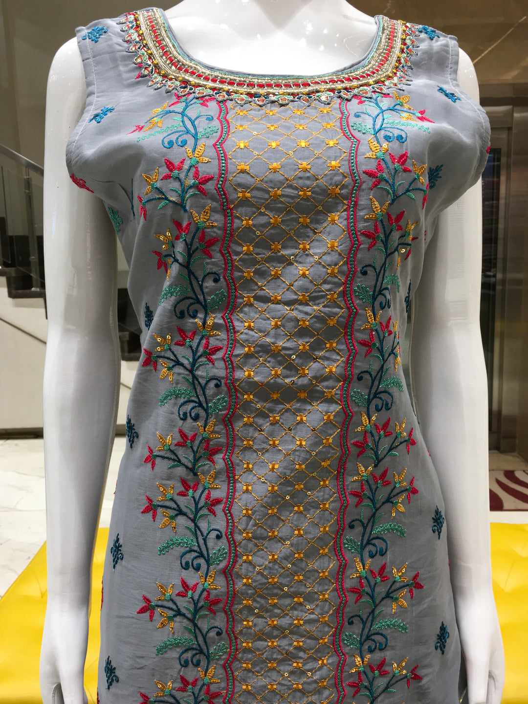 Chanderi Cotton Straight Cut Salwar Kameez with multicolor floral thread embroidery, pencil pants, and a dual-tone chiffon dupatta with sequin detailing.