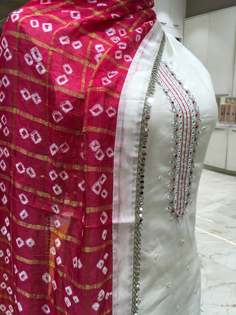 Cream Chanderi Cotton Straight Cut Salwar Kameez with thread embroidery, mirror detailing, pencil pant, and bandhani printed chiffon dupatta.