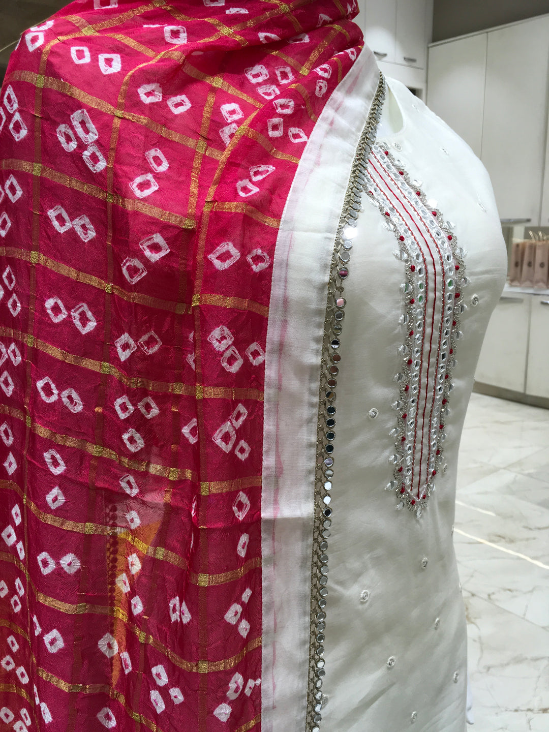 Cream Chanderi Cotton Straight Cut Salwar Kameez with thread embroidery, mirror detailing, pencil pant, and bandhani printed chiffon dupatta.