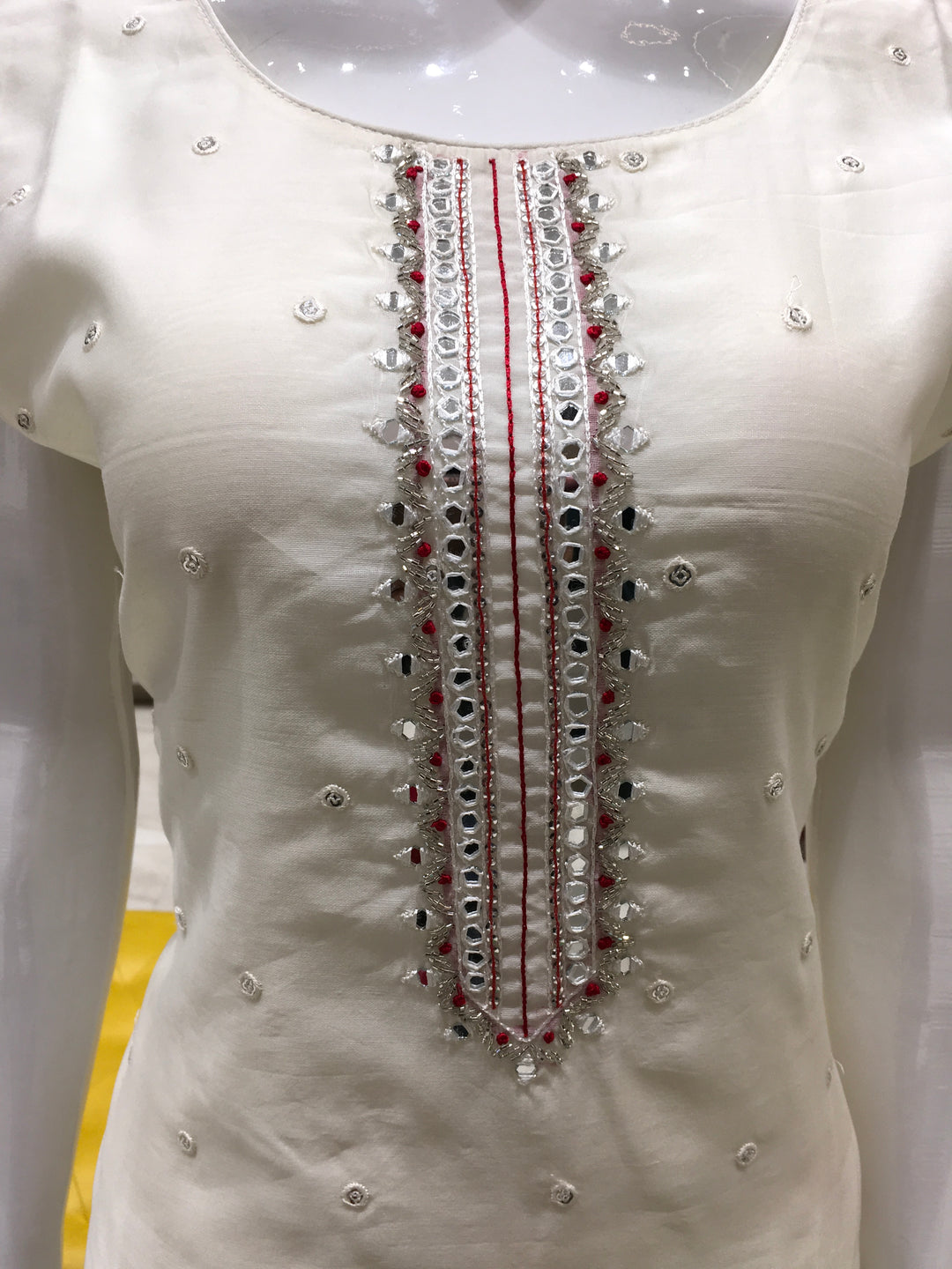 Cream Chanderi Cotton Straight Cut Salwar Kameez with thread embroidery, mirror detailing, pencil pant, and bandhani printed chiffon dupatta.