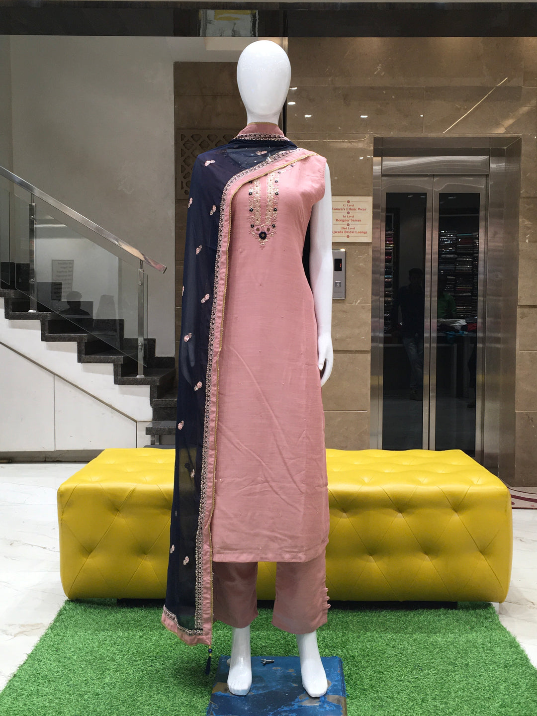 Peachy Pink Muslin Silk Straight Cut Salwar Kameez with embroidered neckline, sequins, and contrast dupatta displayed on mannequin.